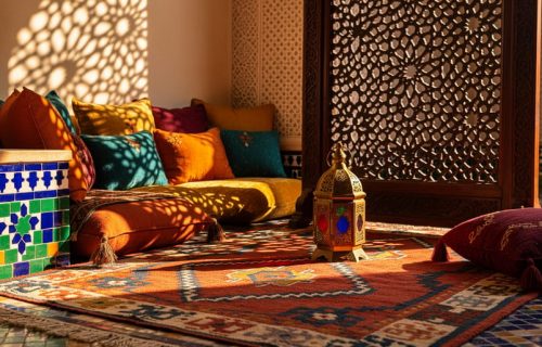 Moroccan living room scene with zellige tiles, a carved wooden screen casting geometric shadows, a brass lantern, a woven kilim rug, and plush jewel-toned cushions.